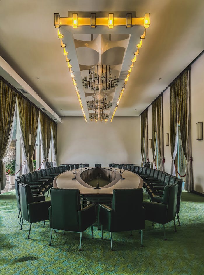A spacious, modern conference room featuring elegant design and large windows, perfect for business meetings.